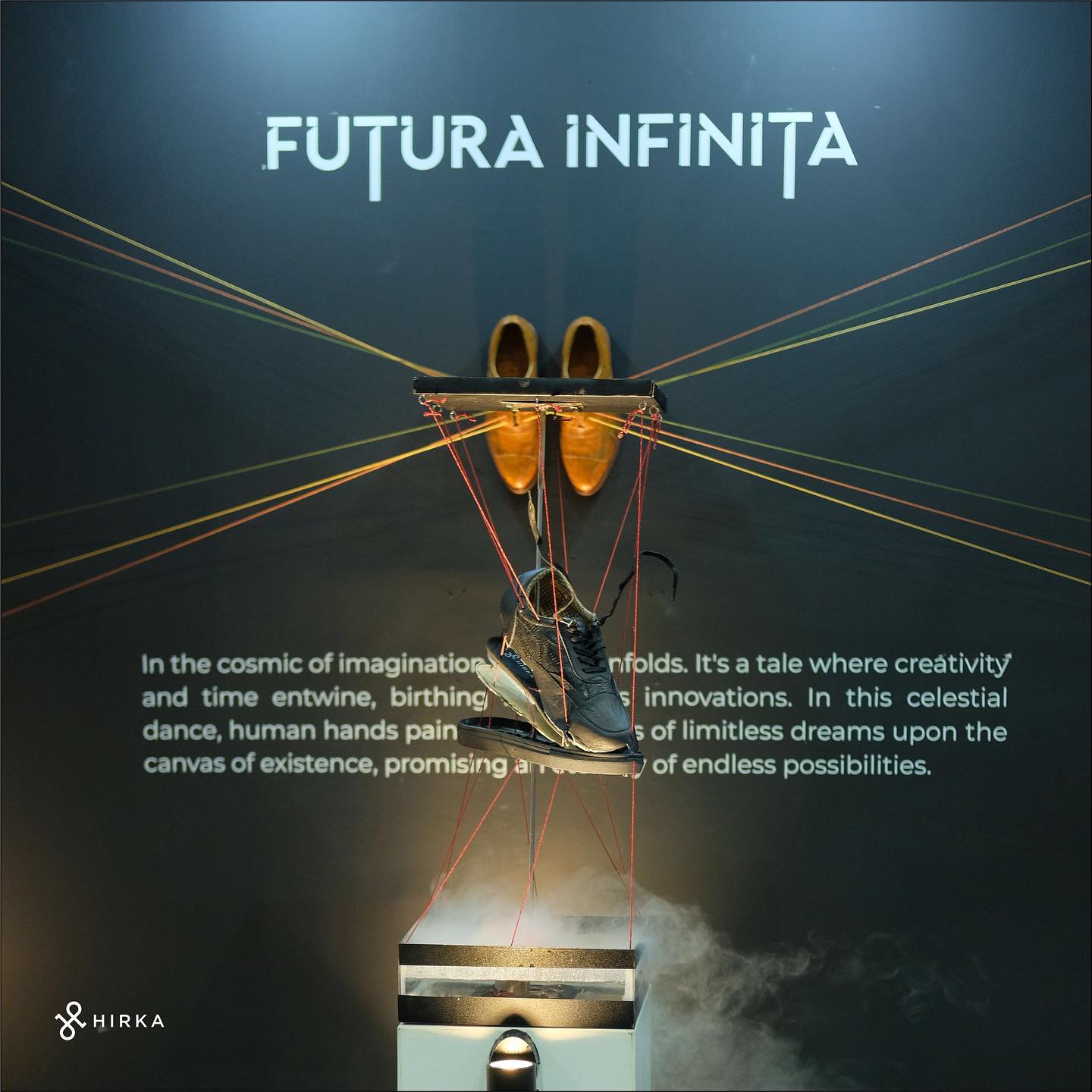 Dua pasang sepatu kulit Hirka yang dipamerkan di depan tulisan Futura Infinita